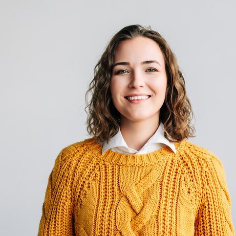 Cheerful Young Woman. Smiling, Positive, and Joyful. Happy Curly-haired Student Laughing, Looking at Camera Isolated on White Background Close-Up Headshot Portrait for Product and Service Advertising